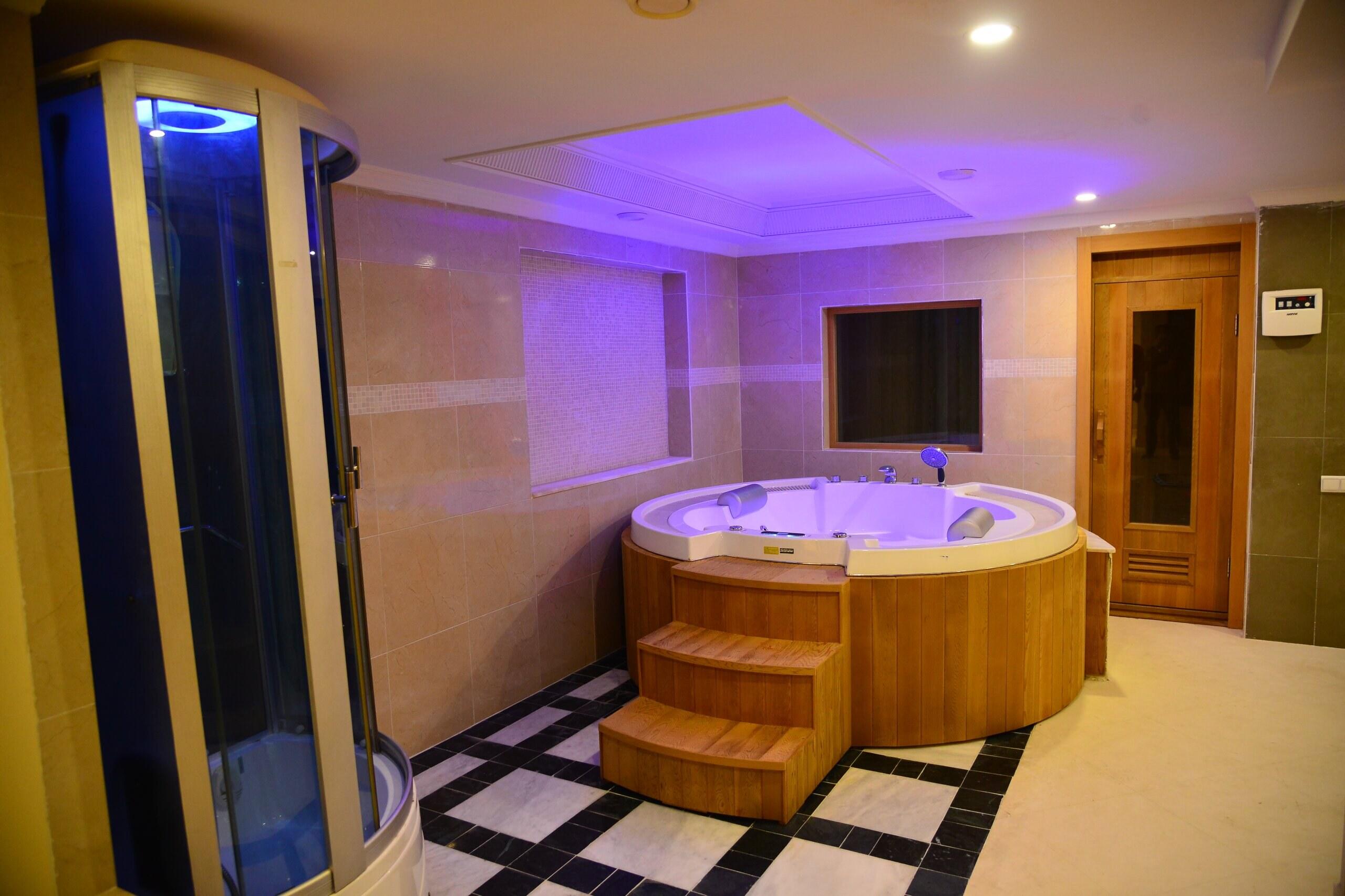 The jacuzzi room in the wellness suite, with the sauna door beside it